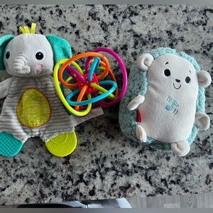 Baby’s toys: Hedgehog Soother, Manhattan toy, and Snuggle & Teethe Plush Teether